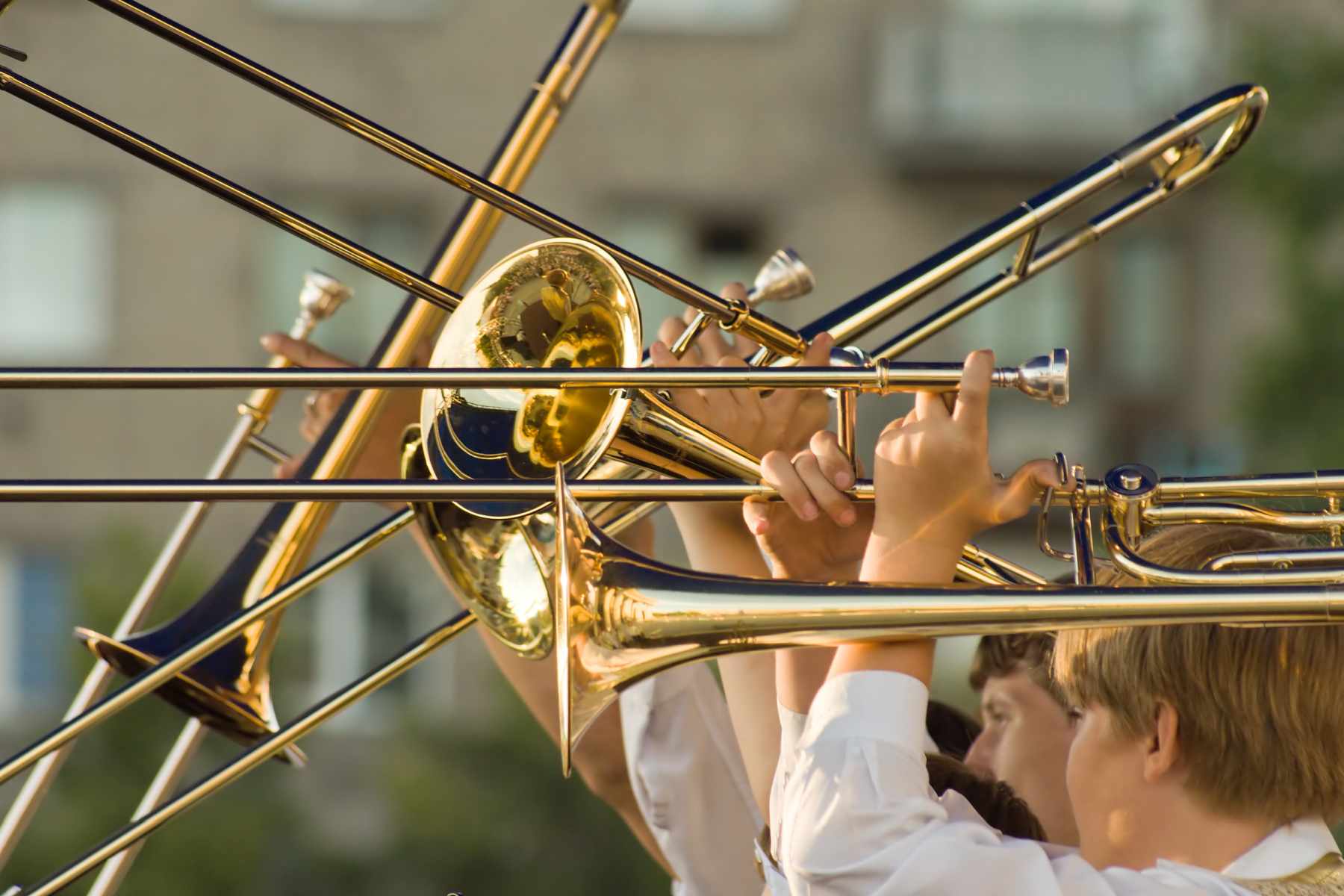 young musicians with trombones in hands